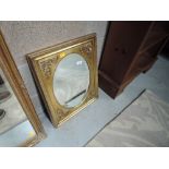 A gilt frame mirror, rectangular frame with oval centre
