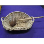 A wicker woven log basket and posser