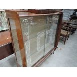 A mid 20th Century walnut display and a mid 20th Century oak bedside cabinet