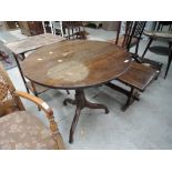 A 19th Century oak pedestal tilt top table