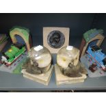 A selection of book ends including Thomas the Tank engine and stone carved Owls