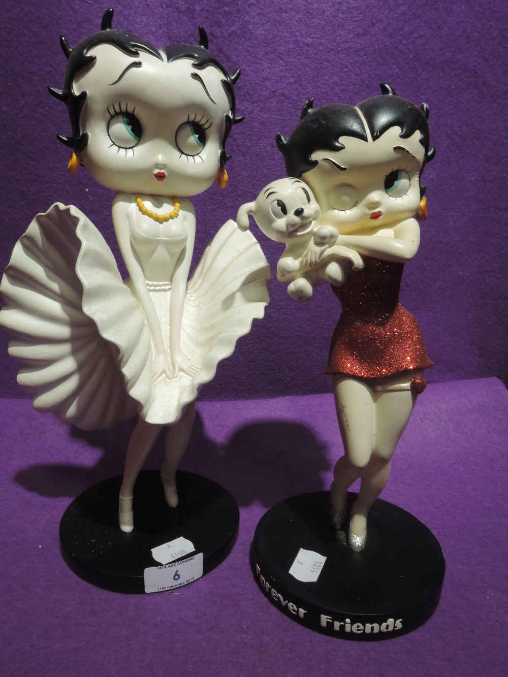 Two cartoon figures of Betty Boop including Marilyn Monroe style and party dress