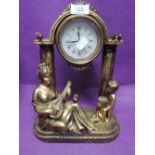 A figural design mantle clock with gilt effect finish