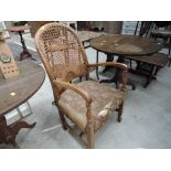 A stained frame armchair with bergere cane back