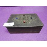 A hand worked trinket or jewellery box with decorative foliate work and beads