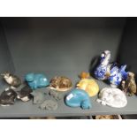 A selection of cat figures and figurines in various mediums