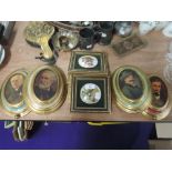A selection of wall mounted ceramic plaques and musical box gilt effect pictures