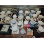 A selection of boxed as new coronation cups and loving cups including Royal Albert, Peter Rabbit