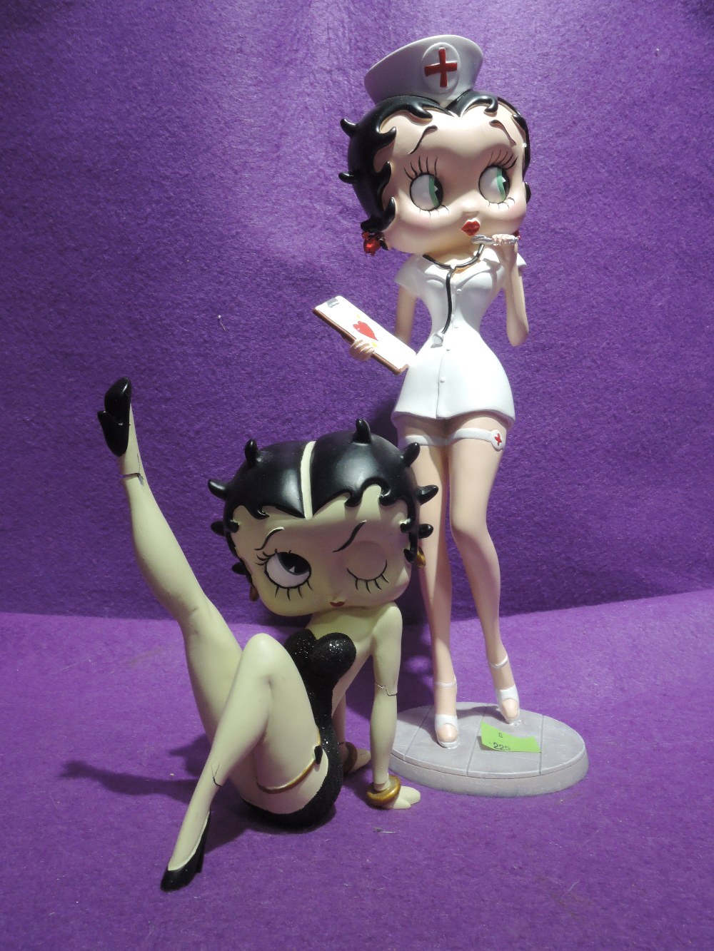 Two cartoon figures of Betty Boop one seated AF and one Nurse figure with box