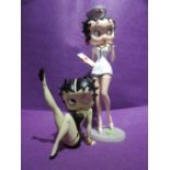 Two cartoon figures of Betty Boop one seated AF and one Nurse figure with box
