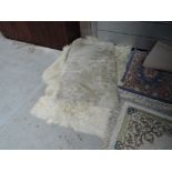 A cream ground fireside rug