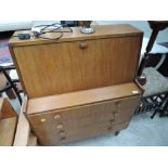 A vintage teak style bureau and drawer unit