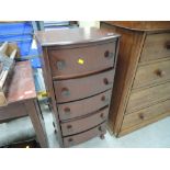 A mid 20th Century stained frame narrow chest of drawers