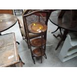 An early 20th Century oak folding cake stand