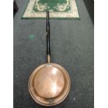 A copper bodied bed warmer