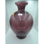 A large purple glass vase