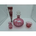 A selection of ruby glass wares including cut and etched vase