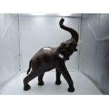 A figure of an African elephant with hand worked leather skin