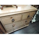 A stripped pine chest of two over two drawers