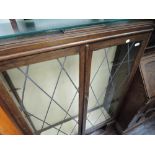 An early to mid 20th Century oak display cabinet