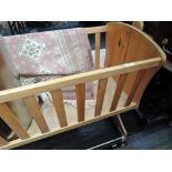 A traditional pine rocking crib/cradle
