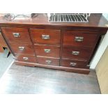 A modern hardwood chest of 9 drawers