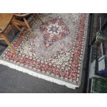 A vintage fireside rug with cream blue and burgundy ground