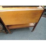 A vintage teak tea trolley