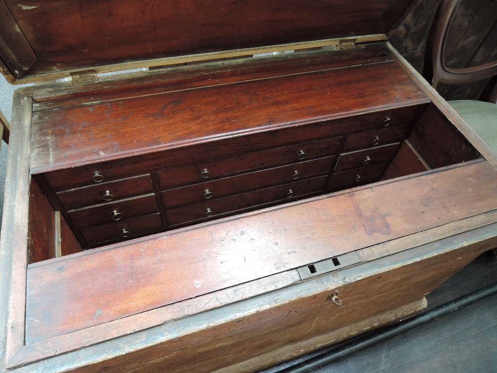 A 19th century scumbled pine tool chest having fully fitted mahogany drawer interior and some