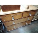 A stripped pine chest of two over two drawers