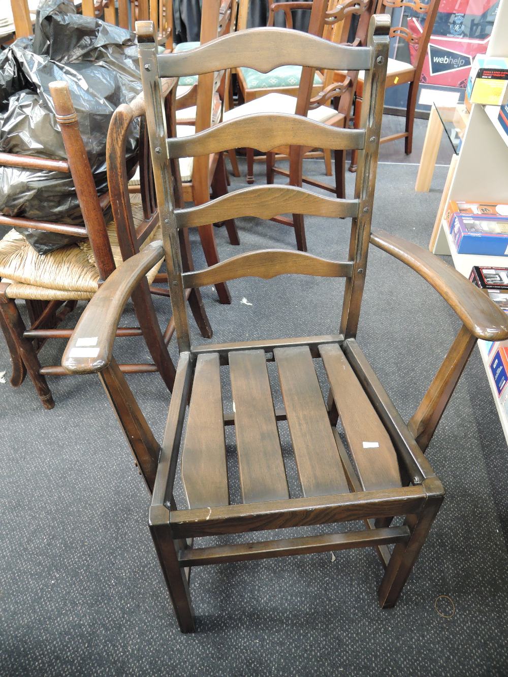 A pair of dark ercol style carver chairs