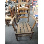 A pair of dark ercol style carver chairs