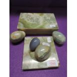 A selection of onyx style carved eggs and trinket box