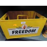 A yellow plastic beer or bottle crate advertising Freedom