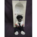 A Sasha doll, Black Baby wearing white and red shirt with dungarees 4-509 in original box