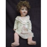 An early 20th century Armand Marseille bisque headed doll having sleep eyes, open mouth with two