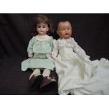 An early 20th century Armand Marseille bisque headed doll having sleep eyes, open mouth with four