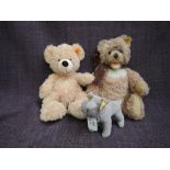 Three modern Steiff soft toys, bears and dog all having yellow tag in ears