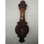 An ornately carved barometer housing case