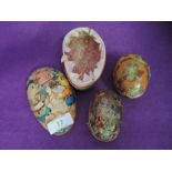 A selection of papier mache egg containers with decoupage decorations