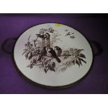 A ceramic tray with printed garden bird design and brass rim with twin handles