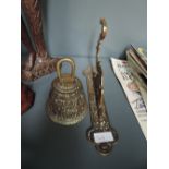 A heavy cast brass bell and wall bracket with Indian design