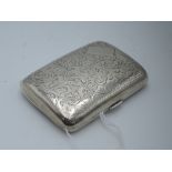 A silver cigarette case having engraved scroll decoration and plain cartouche, Birmingham 1925, S