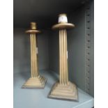 A pair of heavy set and cast Corinthian column design candle sticks