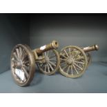 A pair of heavy set and cast model replica cannons