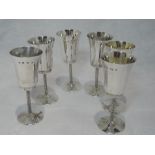 A set of six silver liqueur goblets of plain form having moulded bark effect stems, Birmingham 1976,