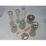 A selection of cut glass dressing table pots and vases having HM silver collars and lids, and