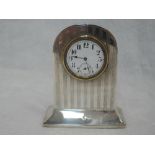 A small silver cased mantle clock of dome form having engine turned stripe decoration, Sheffield