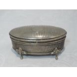 A silver dressing table box of oval form having engine turned stripe decoration, to hinged lid,