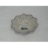 A Victorian silver trinket dish of circular form having moulded scroll and scallop decoration and